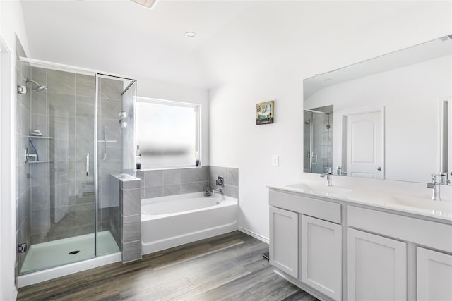 17718 Sommerset Falls Ln, Crosby, TX 77532 - bathroom featuring a shower stall, a garden tub, double vanity, wood finished floors, and recessed lighting