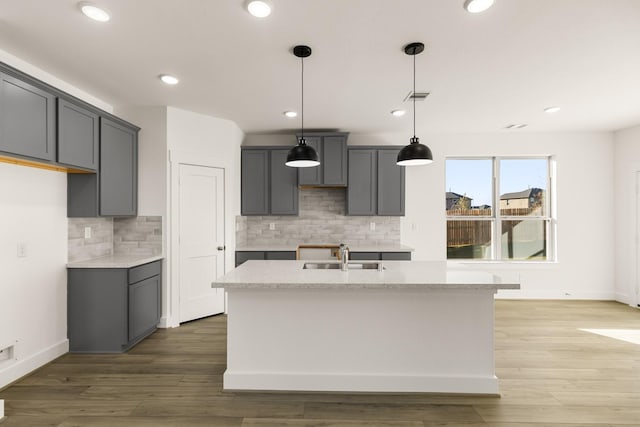 4826 Sand Clouds, Katy, TX 77493 - kitchen with a sink, gray cabinets, tasteful backsplash, an island with sink, and recessed lighting