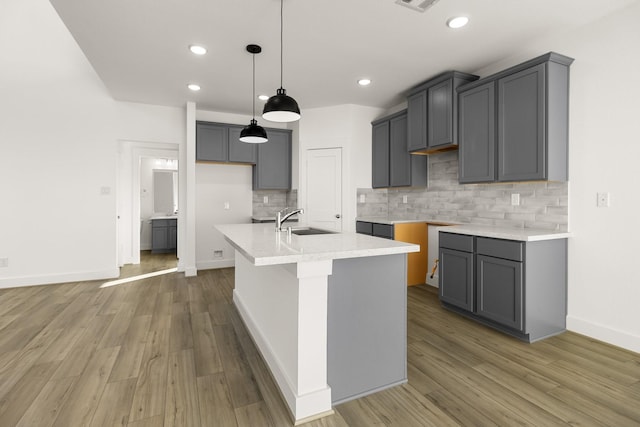 4826 Sand Clouds, Katy, TX 77493 - kitchen featuring a sink, backsplash, a center island with sink, baseboards, and recessed lighting