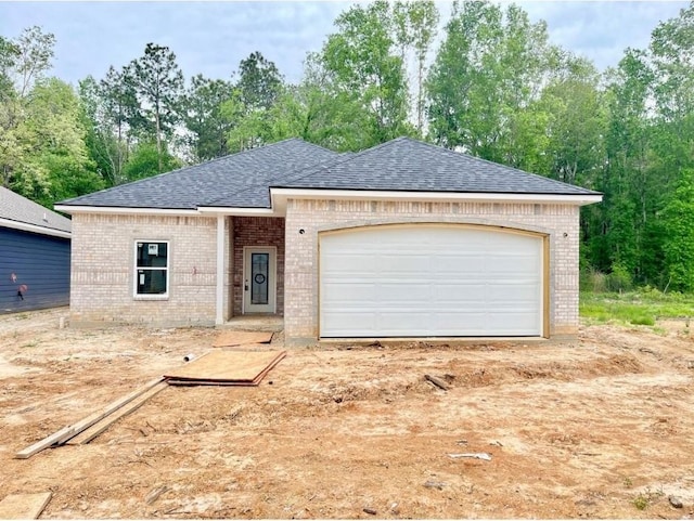 10730 Vinson St, Beaumont, TX 77713 - view of front facade featuring brick siding, a shingled roof, an attached garage, and driveway