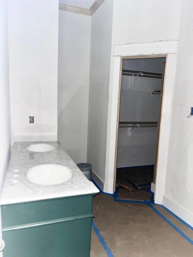 10730 Vinson St, Beaumont, TX 77713 - bathroom featuring vanity, baseboards, a walk in closet, and concrete flooring