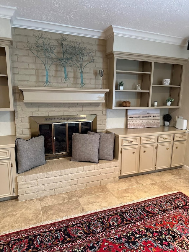 living area with ornamental molding, a textured ceiling, and a fireplace