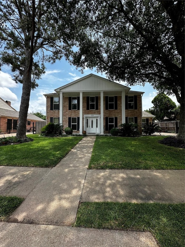 neoclassical home with brick siding