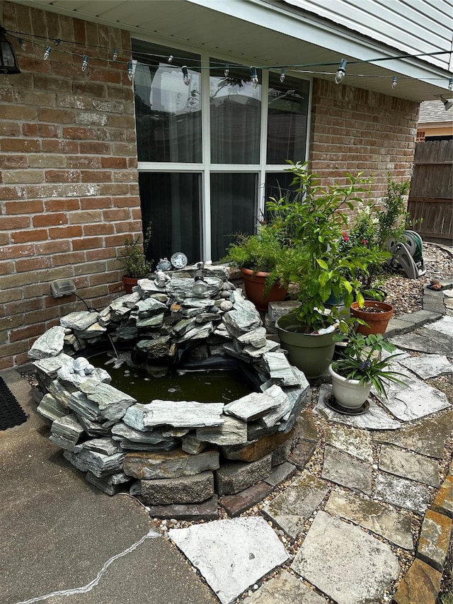 exterior view of a garden pond and brick siding
