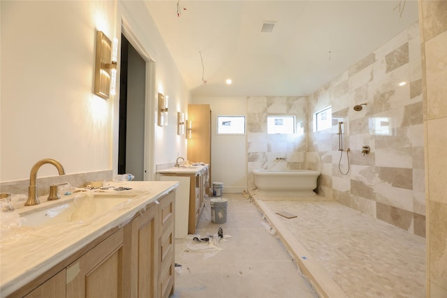 1032 W 41st St, Houston, TX 77018 - bathroom featuring a tile shower, a soaking tub, two vanities, and lofted ceiling
