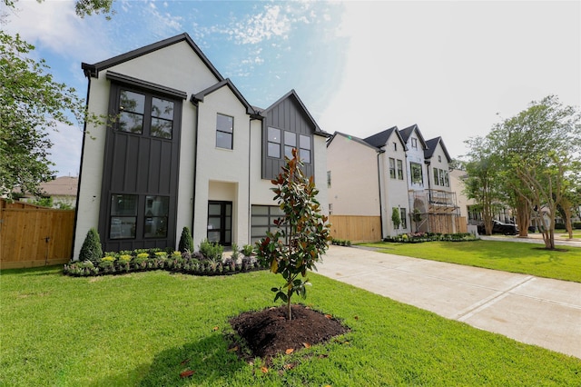 1032 W 41st St, Houston, TX 77018 - view of front facade featuring board and batten siding, driveway, and an attached garage