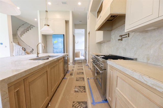 1032 W 41st St, Houston, TX 77018 - kitchen featuring a sink, stainless steel appliances, light stone countertops, decorative backsplash, and hanging light fixtures