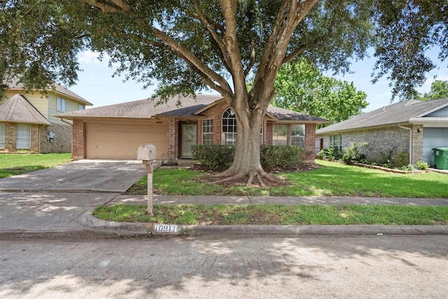10911 Cedar Bridge St, Houston, TX 77075 - ranch-style house with brick siding, a garage, a front lawn, and concrete driveway