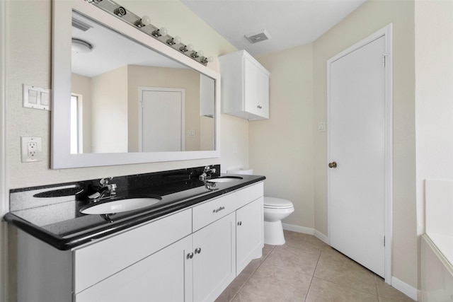 10911 Cedar Bridge St, Houston, TX 77075 - bathroom featuring double vanity, toilet, tile patterned flooring, and baseboards