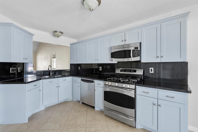 10911 Cedar Bridge St, Houston, TX 77075 - kitchen with stainless steel appliances, a sink, dark countertops, tasteful backsplash, and light tile patterned floors