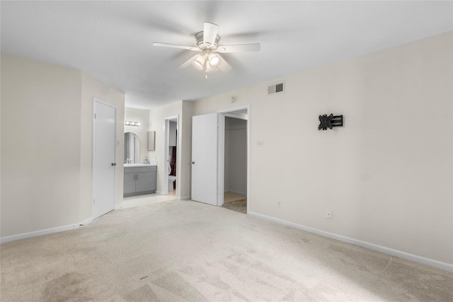 2601 S Braeswood Blvd S Unit 1403, Houston, TX 77025 - unfurnished bedroom with light carpet, a spacious closet, connected bathroom, and baseboards