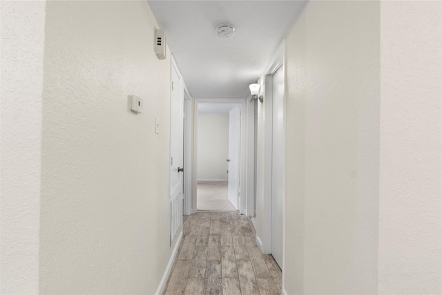 2601 S Braeswood Blvd S Unit 1403, Houston, TX 77025 - hall with light wood-style floors and baseboards