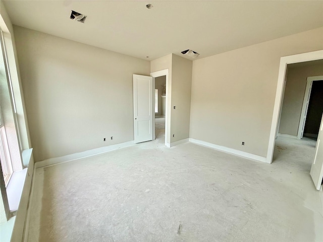 24538 Greeley Lake Dr, Katy, TX 77493 - unfurnished bedroom featuring unfinished concrete flooring and baseboards