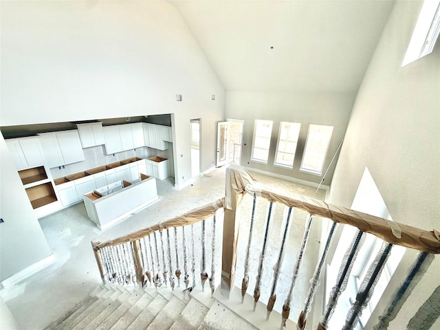 24538 Greeley Lake Dr, Katy, TX 77493 - staircase featuring high vaulted ceiling and baseboards