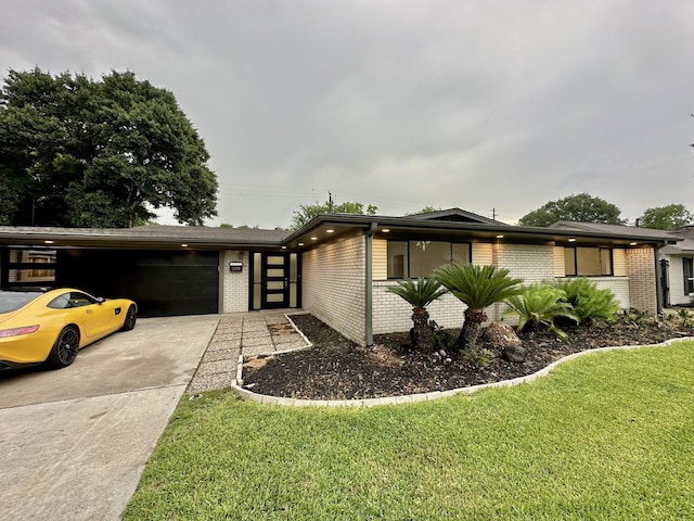 5450 Ariel St, Houston, TX 77096 - view of front of house with brick siding, a garage, driveway, and a front lawn