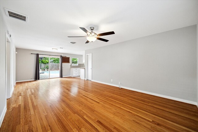 2009 Sedgie Dr, Houston, TX 77080 - unfurnished living room with a ceiling fan, baseboards, and light wood-style flooring