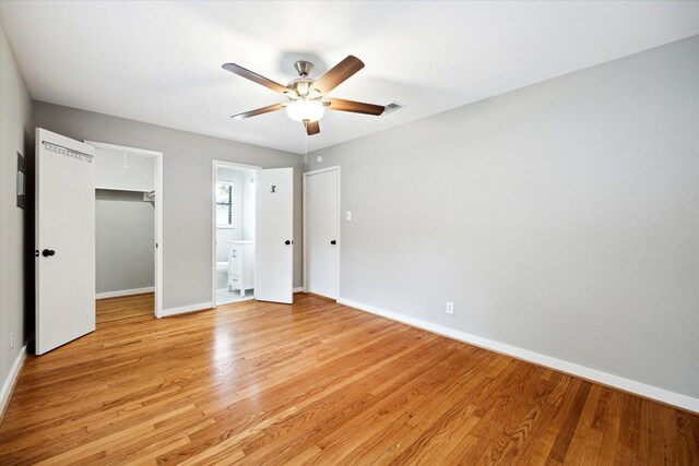 2009 Sedgie Dr, Houston, TX 77080 - unfurnished bedroom with baseboards, a walk in closet, and light wood-type flooring