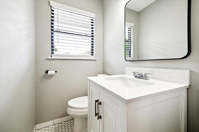 2009 Sedgie Dr, Houston, TX 77080 - bathroom with vanity, toilet, baseboards, and tile patterned floors