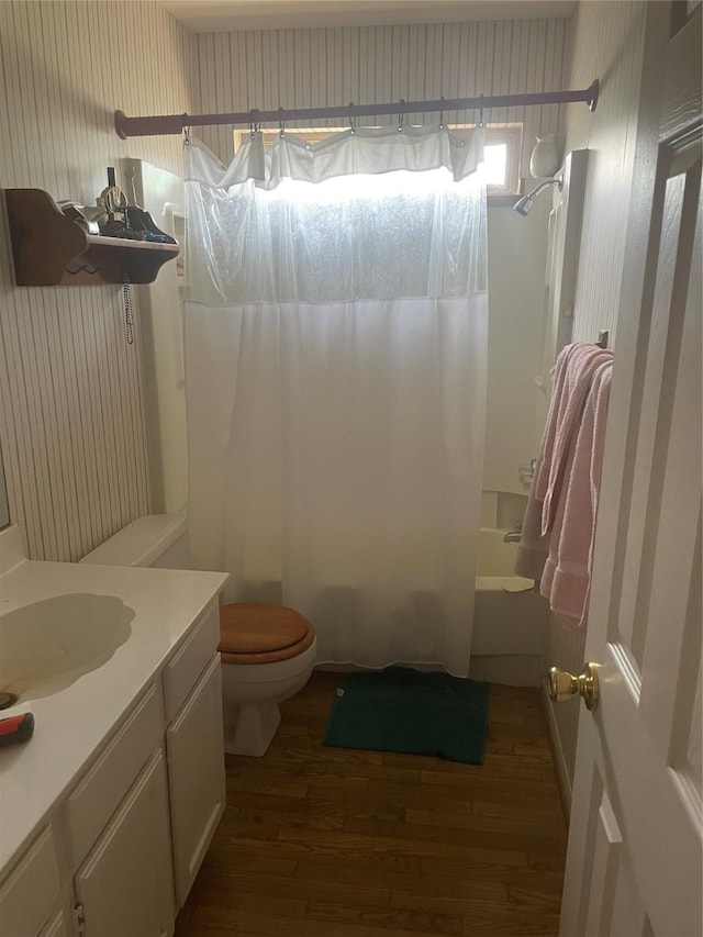 12595 Sagittarius Dr E, Willis, TX 77318 - bathroom featuring wood finished floors, shower / tub combo, toilet, vanity, and wallpapered walls