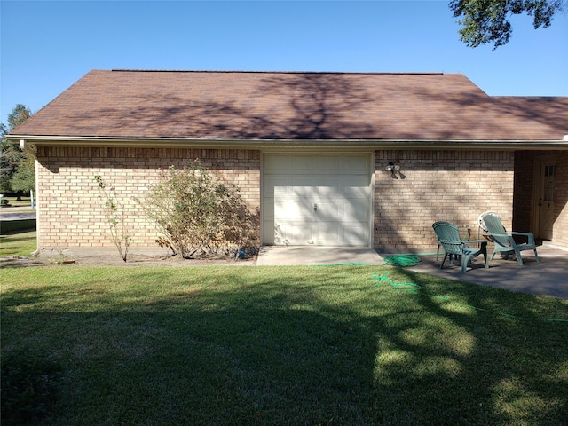 12595 Sagittarius Dr E, Willis, TX 77318 - view of side of home featuring brick siding, a lawn, a garage, and a shingled roof