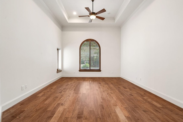 3 Maroon Creek Ct, The Woodlands, TX 77389 - unfurnished room with a tray ceiling, a ceiling fan, ornamental molding, wood finished floors, and baseboards
