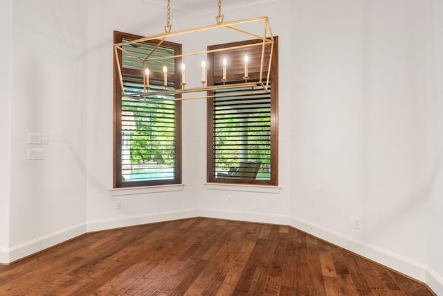 3 Maroon Creek Ct, The Woodlands, TX 77389 - spare room featuring a chandelier, wood finished floors, and baseboards