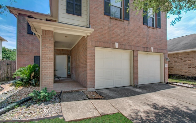 1418 High Thicket Ct, Spring, TX 77373 - property entrance with an attached garage, driveway, and brick siding