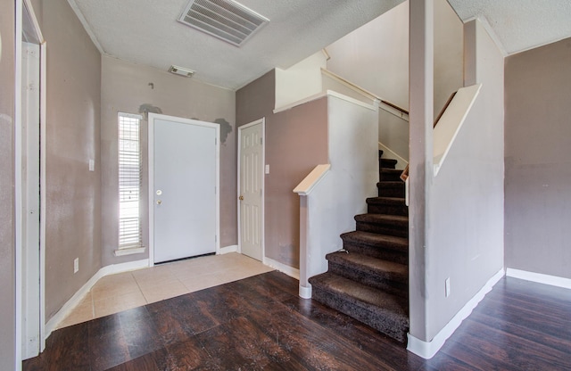 1418 High Thicket Ct, Spring, TX 77373 - entryway featuring wood finished floors, stairs, baseboards, and a textured ceiling