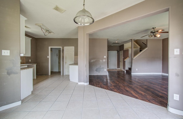1418 High Thicket Ct, Spring, TX 77373 - unfurnished living room with light tile patterned flooring, baseboards, stairway, and ceiling fan