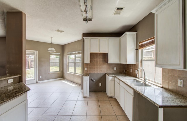 1418 High Thicket Ct, Spring, TX 77373 - kitchen with a sink, decorative backsplash, stone countertops, and light tile patterned flooring