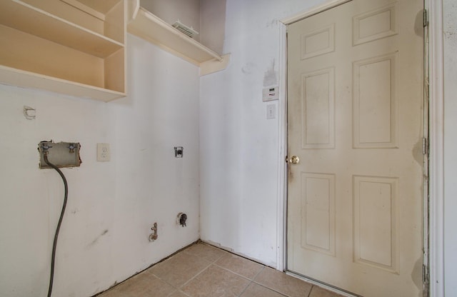1418 High Thicket Ct, Spring, TX 77373 - washroom featuring light tile patterned floors, electric dryer hookup, and hookup for a gas dryer