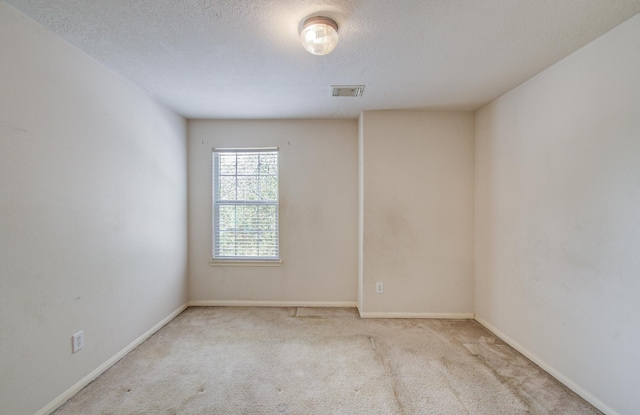 1418 High Thicket Ct, Spring, TX 77373 - spare room with a textured ceiling, carpet, and baseboards