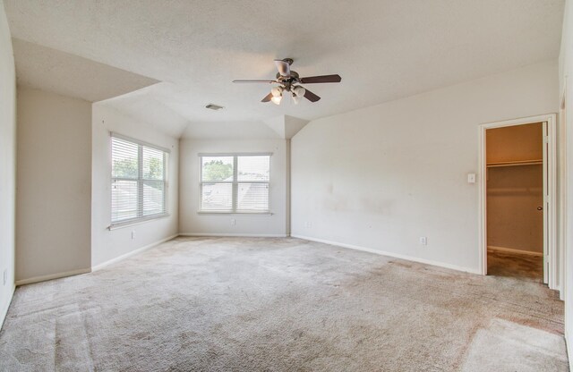 1418 High Thicket Ct, Spring, TX 77373 - spare room featuring carpet floors, a ceiling fan, baseboards, and lofted ceiling