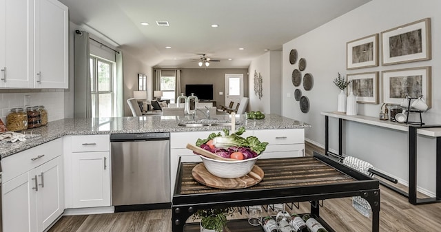 310 Bandit Cove Ct, Crosby, TX 77354 - kitchen featuring dishwasher, a peninsula, wood finished floors, a ceiling fan, and white cabinetry