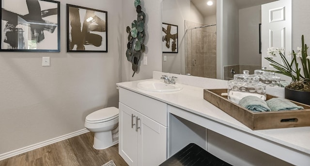 310 Bandit Cove Ct, Crosby, TX 77354 - full bath with wood finished floors, toilet, baseboards, a tile shower, and vanity