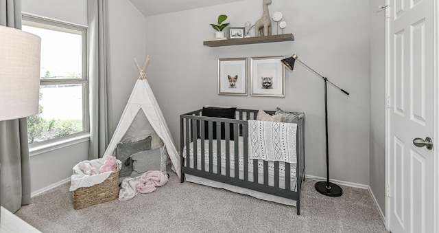 310 Bandit Cove Ct, Crosby, TX 77354 - carpeted bedroom featuring a crib and baseboards