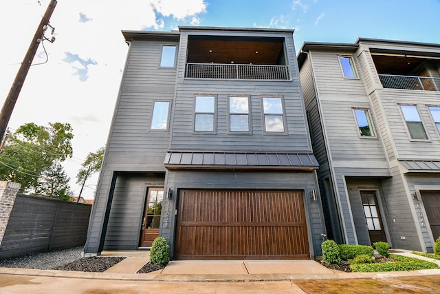 11028 Avenu Malkenu Ave, Houston, TX 77043 - view of front facade with a garage, a standing seam roof, and metal roof