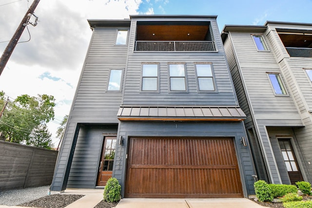 11028 Avenu Malkenu Ave, Houston, TX 77043 - view of front of property featuring driveway, a standing seam roof, a garage, and metal roof