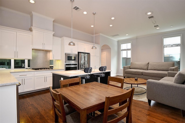 11028 Avenu Malkenu Ave, Houston, TX 77043 - dining room featuring arched walkways, ornamental molding, dark wood-style flooring, and recessed lighting
