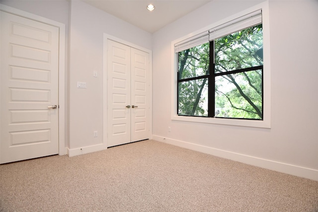 11028 Avenu Malkenu Ave, Houston, TX 77043 - unfurnished bedroom with light colored carpet, baseboards, a closet, and recessed lighting