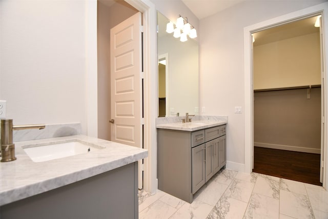 11028 Avenu Malkenu Ave, Houston, TX 77043 - full bathroom with marble look tile flooring, vanity, baseboards, and a spacious closet