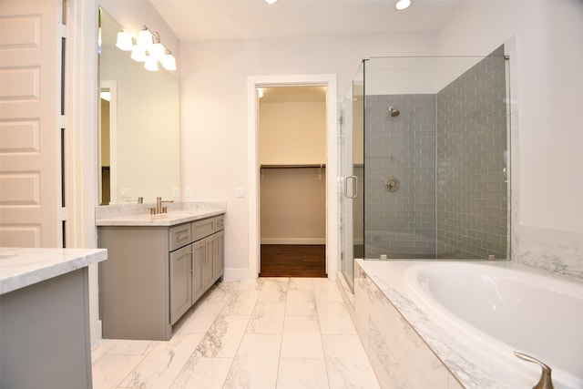 11028 Avenu Malkenu Ave, Houston, TX 77043 - bathroom with a stall shower, marble finish floors, a bath, vanity, and recessed lighting