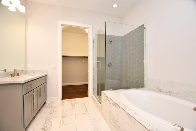 11028 Avenu Malkenu Ave, Houston, TX 77043 - bathroom featuring a shower stall, marble finish floors, a garden tub, vanity, and a walk in closet