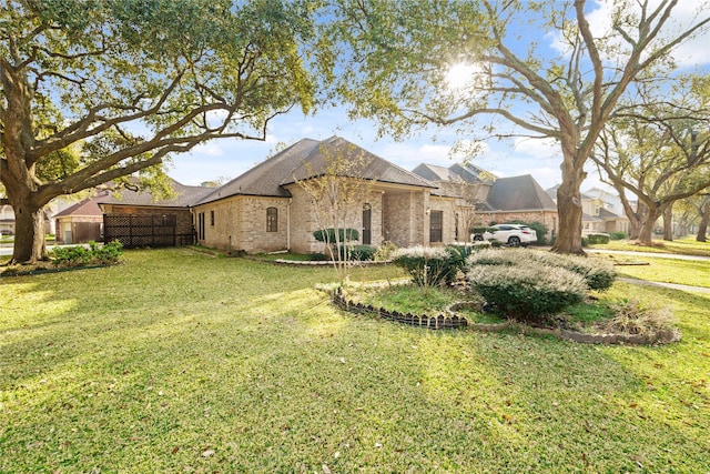 1015 Flagmore Dr, Katy, TX 77450 - view of side of home with a yard, brick siding, and roof with shingles