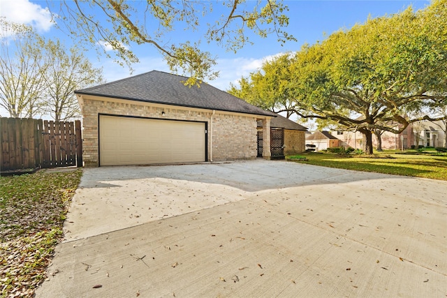 1015 Flagmore Dr, Katy, TX 77450 - view of side of property featuring driveway, roof with shingles, a garage, and brick siding