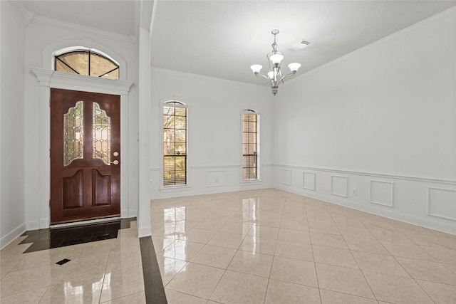 1015 Flagmore Dr, Katy, TX 77450 - foyer with a chandelier, crown molding, inlaid floor details, wainscoting, and baseboards