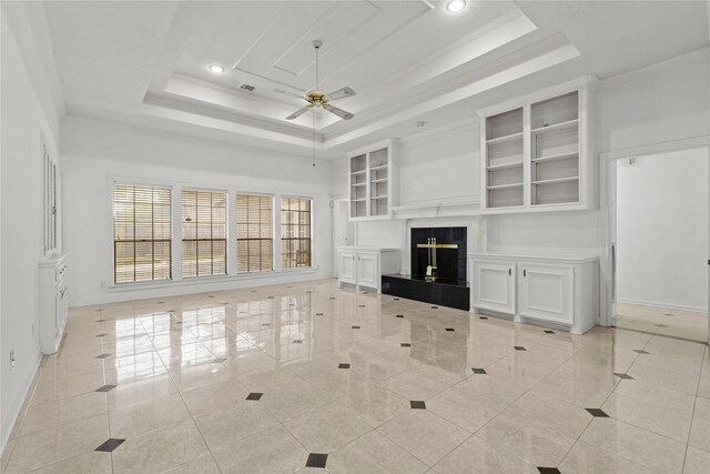 1015 Flagmore Dr, Katy, TX 77450 - unfurnished living room featuring ceiling fan, a tray ceiling, baseboards, a fireplace, and recessed lighting