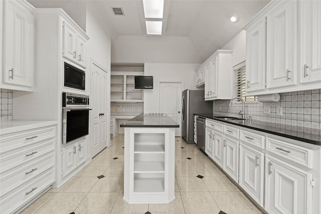 1015 Flagmore Dr, Katy, TX 77450 - kitchen featuring black appliances, a sink, decorative backsplash, light tile patterned floors, and vaulted ceiling