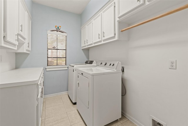 1015 Flagmore Dr, Katy, TX 77450 - laundry area featuring cabinet space, washing machine and clothes dryer, baseboards, and light tile patterned flooring