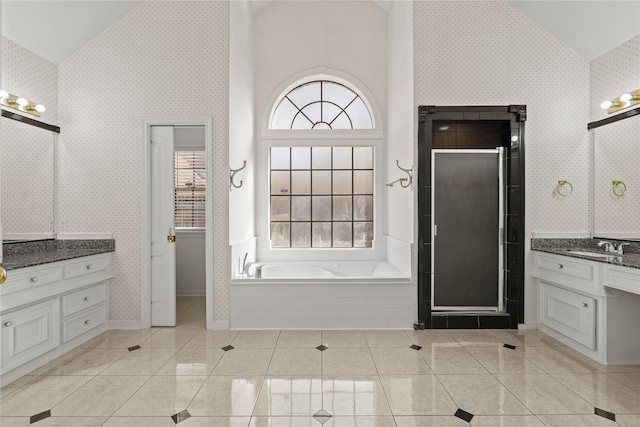 1015 Flagmore Dr, Katy, TX 77450 - bathroom with high vaulted ceiling, a shower stall, vanity, tile patterned floors, and a garden tub